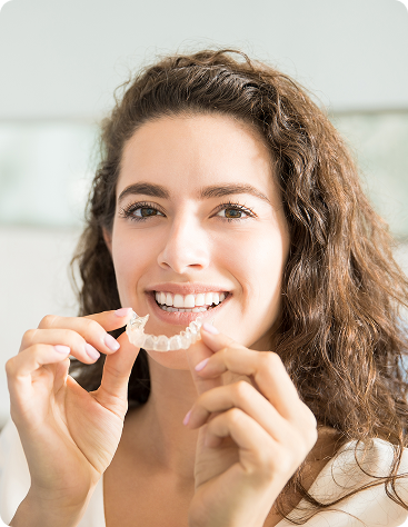 portrait-beautiful-patient-holding-orthodontic-retainers-dental-clinic